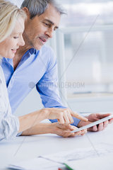 Businesspeople using digital tablet