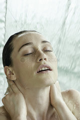 Woman bathing in artificial waterfall