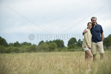 Couple standing together in tall grass