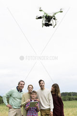 Family playing with drone together