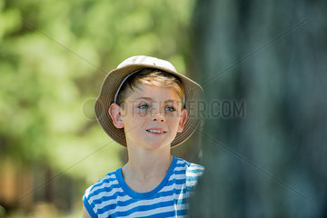 Boy wearing hat outdoors in summer  portrait