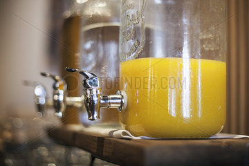 Orange juice in glass dispenser