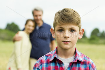 Boy with parents in background  portrait