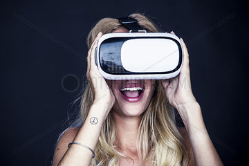 Young woman using virtual reality simulator
