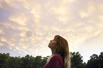 Young woman gazing at evening sky