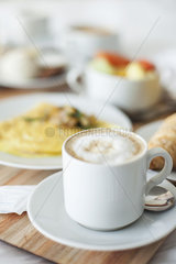 Cappuccino and breakfast on tray