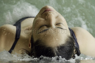 Woman relaxing in spa tub