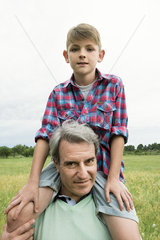 Grandfather carrying grandson on shoulders  portrait