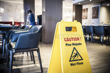 Woman mopping restaurant floor