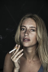 Young woman smoking cigarette  portrait