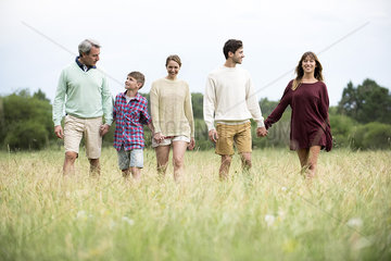 Family walking together in field