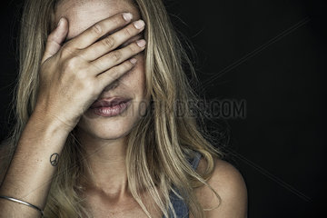 Woman covering face with hand