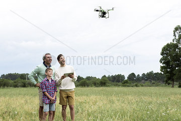 Multi-generation family playing with drone