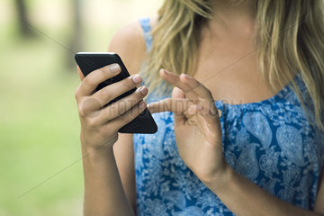 Woman using smartphone  cropped
