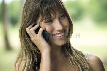 Young woman talking on cell phone and smiling