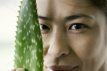 Woman with aloe vera leaf