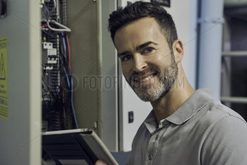 Man working in electrical control cabinet