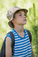 Boy outdoors  looking up attentively