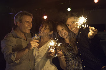 Friends celebrating with sparklers and champagne