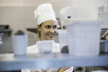 Young female chef in commercial kitchen