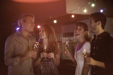 People drinking champagne together outdoors