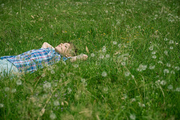 Boy napping on grass