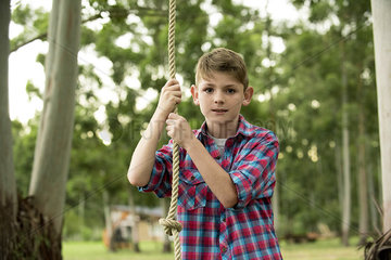 Boy on rope swing  portrait
