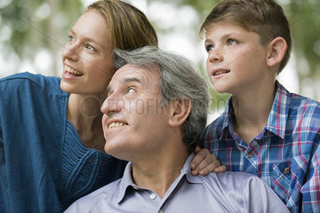 Family smiling together and looking away  portrait