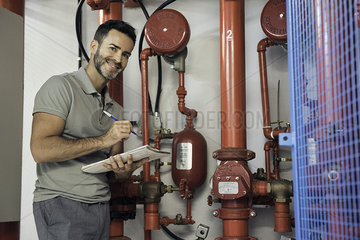 Man inspecting fire protection sprinkler system