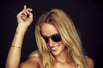 Young woman wearing sunglasses and dancing  portrait