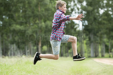 Boy jumping in midair