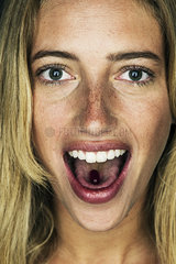 Young woman with gel capsule on tongue  portrait