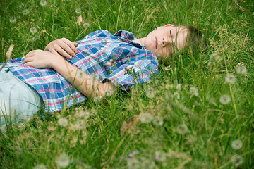 Boy napping on grass