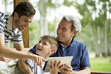 Family with child using digital tablet