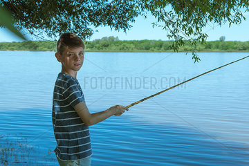 Boy fishing at lake  portrait