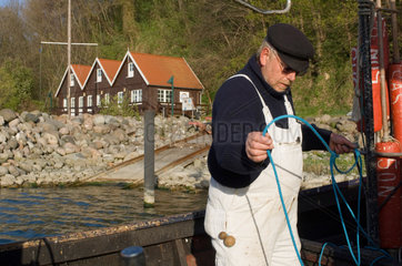 Lohme  Deutschland  ein Fischer in seinem Boot am Hafen