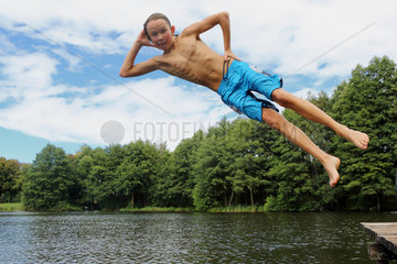 Emstal  Deutschland  Junge springt in cooler Pose im Freibad ins Wasser