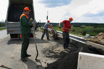 Bobrujsk  Weissrussland  Arbeiter bei der Asphaltierung einer Bruecke