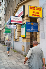 Poznan  Polen  Leuchtreklamen und Werbeschilder an einer Hausfassade