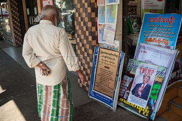 Yangon  Myanmar  Mann geht an einem Kiosk vorbei