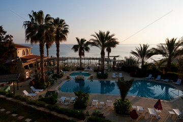 Girne  Tuerkische Republik Nordzypern  Hotelanlage mit Swimmingpool im Sonnenaufgang
