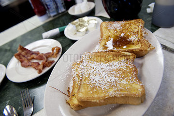 French toast and bacon on restaurant table