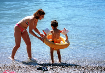 Badefreuden am Gardasee - Mutter ist ihrem Kind behilflich