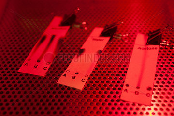 Chemical test strips illuminated by red light