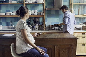 Couple together at home in kitchen