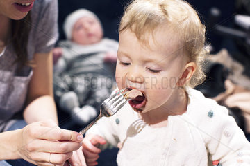 Mother feeding toddler