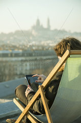 Man using digital tablet on rooftop terrace