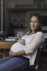 Pregnant woman cradling belly  portrait