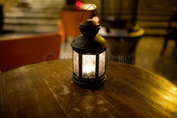 Illuminated lantern on table