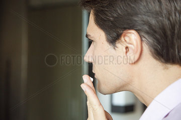 Man applying moisturizer to face